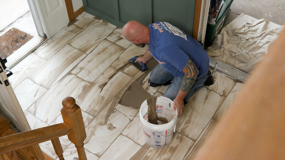 spreading grout into joints